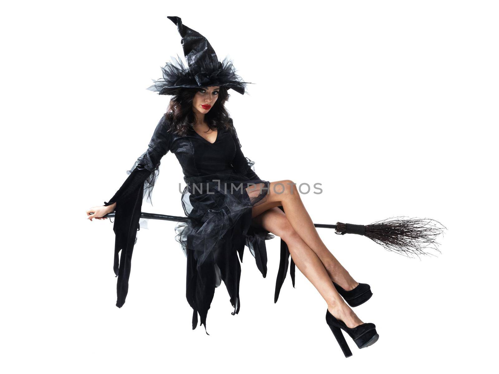 Beautiful Halloween witch flying on a broomstick isolated on white background