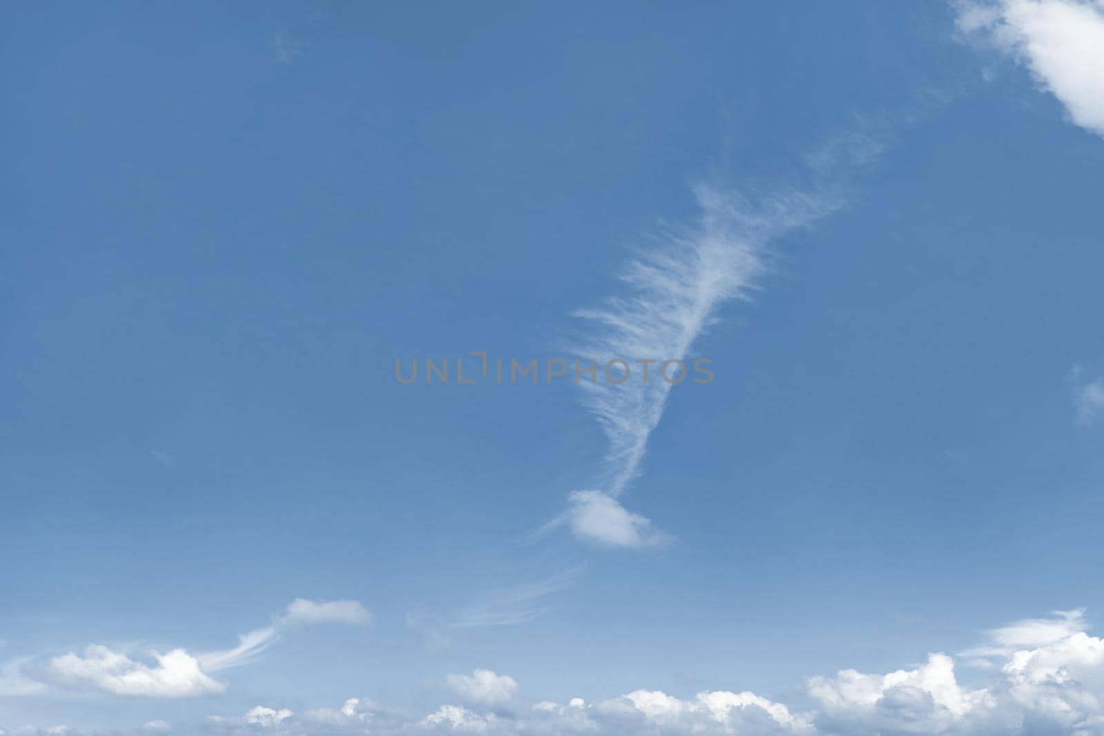 Photo of blue sky with strangely shaped cloud.