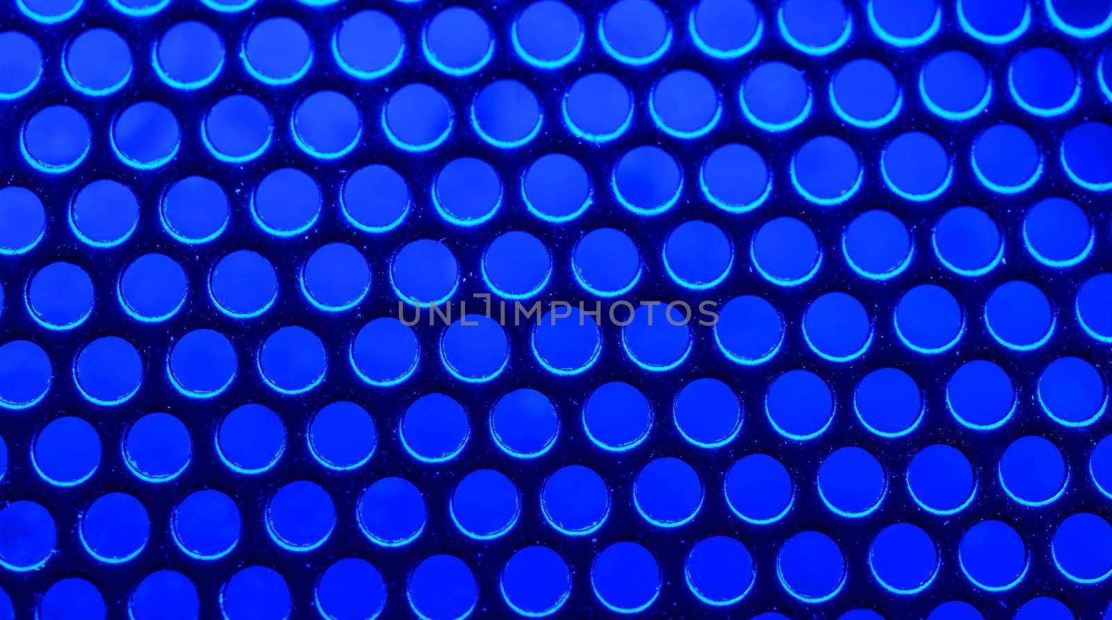 Metallic mesh under the neon blue light - macro photo. Background picture. High quality photo