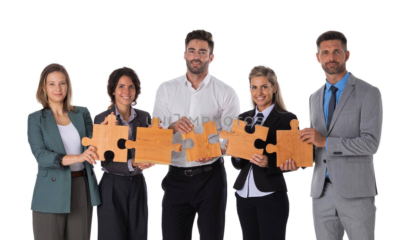 Group of business people assembling jigsaw puzzle Isolated on white background