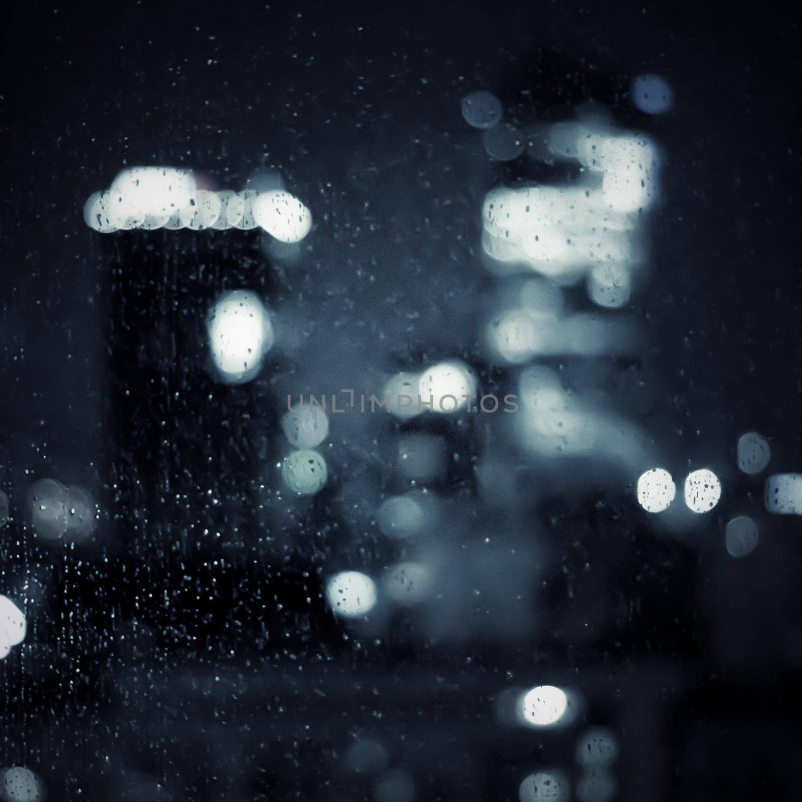 Big metropolitan city lights at night, blurry background - night life, abstract background and modern dark tones concept