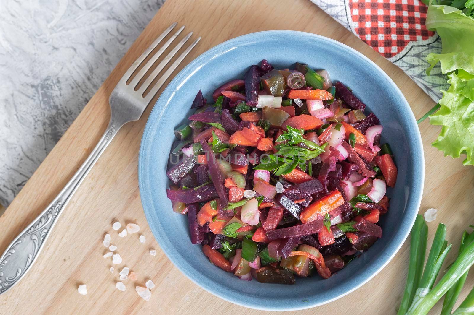 Vinaigrette with beetroot and boiled vegetables, traditional Russian homemade salad. Healthy food with vegetables for vegetarian dietary nutrition. View from above.