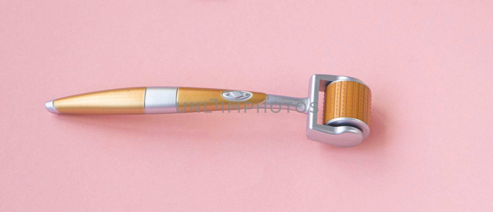 Mezoroller, dermaroller, mesotherapy skin tool. pink background. Roller set with microscopic needles. Stimulate collage. beauty pain concept.n production. High quality photo