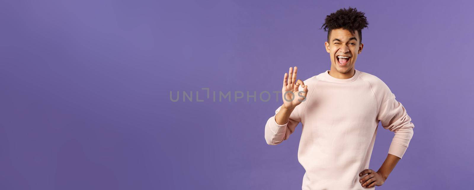 Portrait of enthusiastic young relaxed man show no problem, guarantee gesture, recommend awesome courses where you easily learn new languages, smiling and show ok to assure you by Benzoix