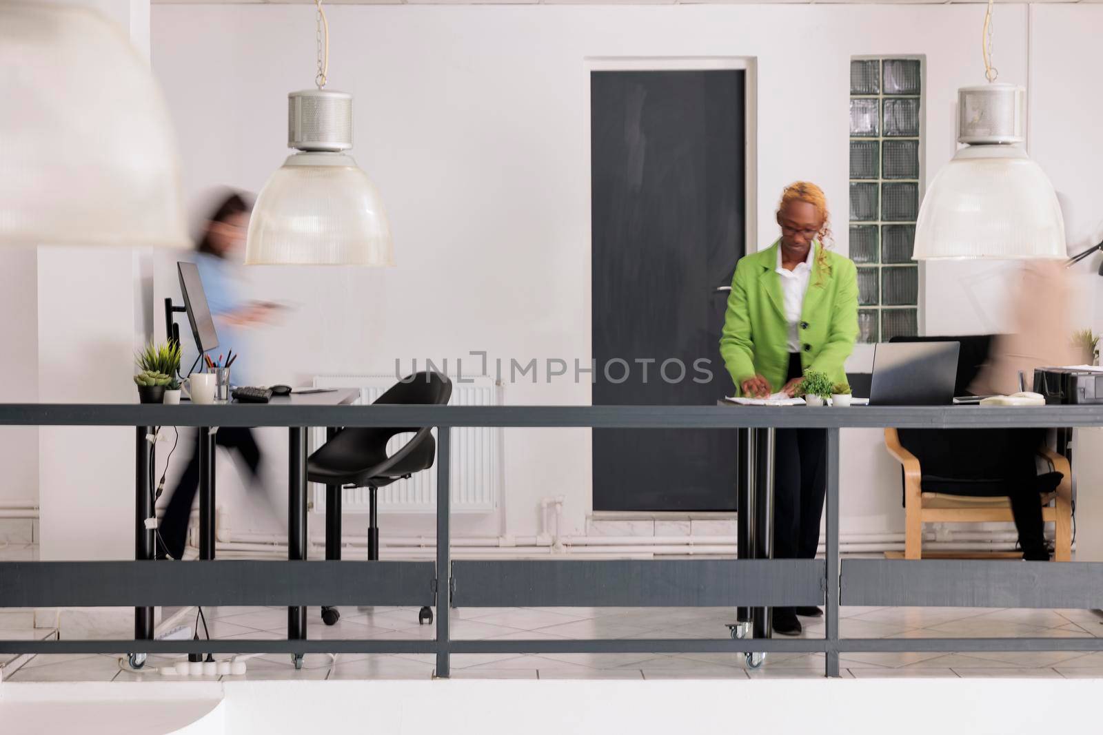 Employees silhouettes walking in business coworking space, blur effect by DCStudio