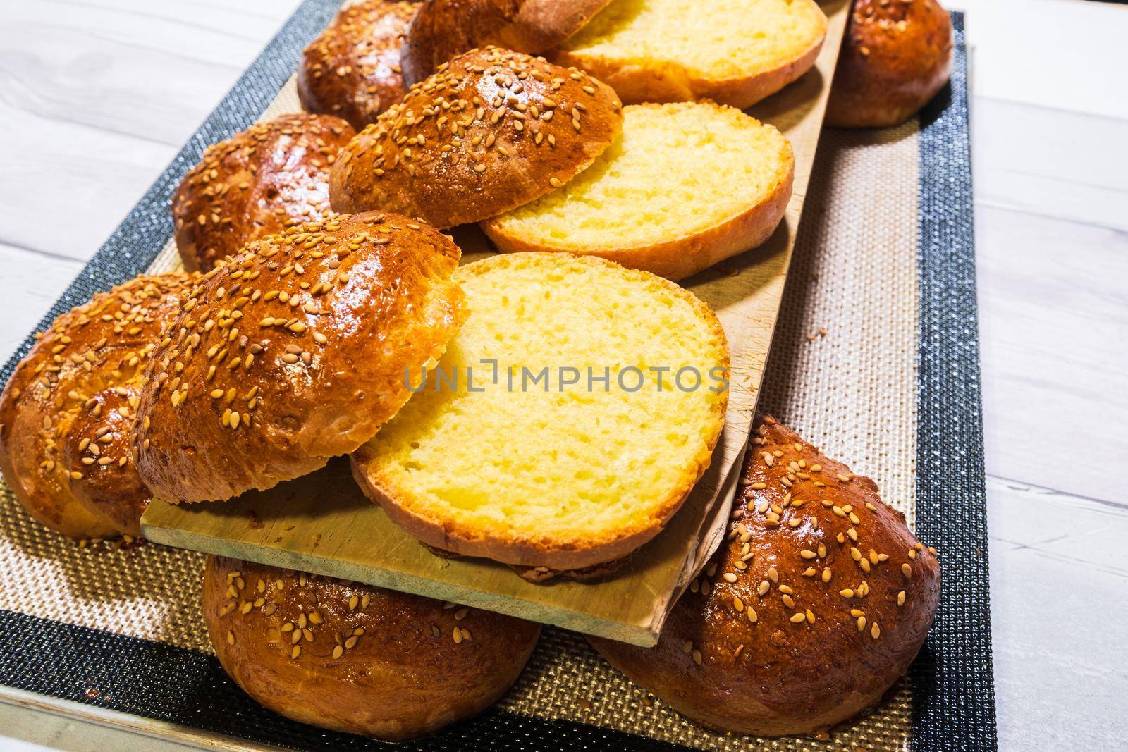 freshly baked buns cut to make pulled pork hamburger