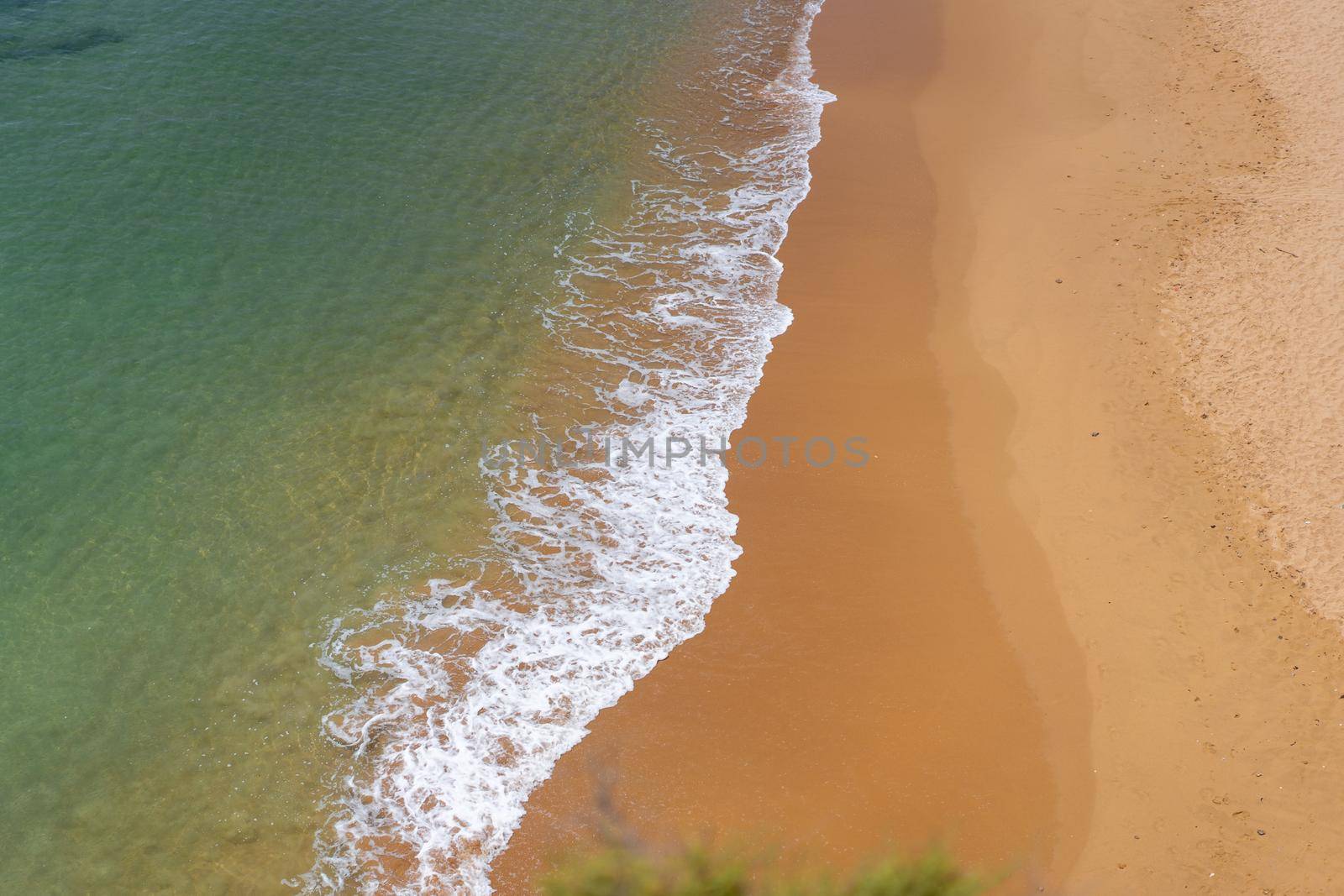 Aerial view of sea waves and sandy beach by andreonegin