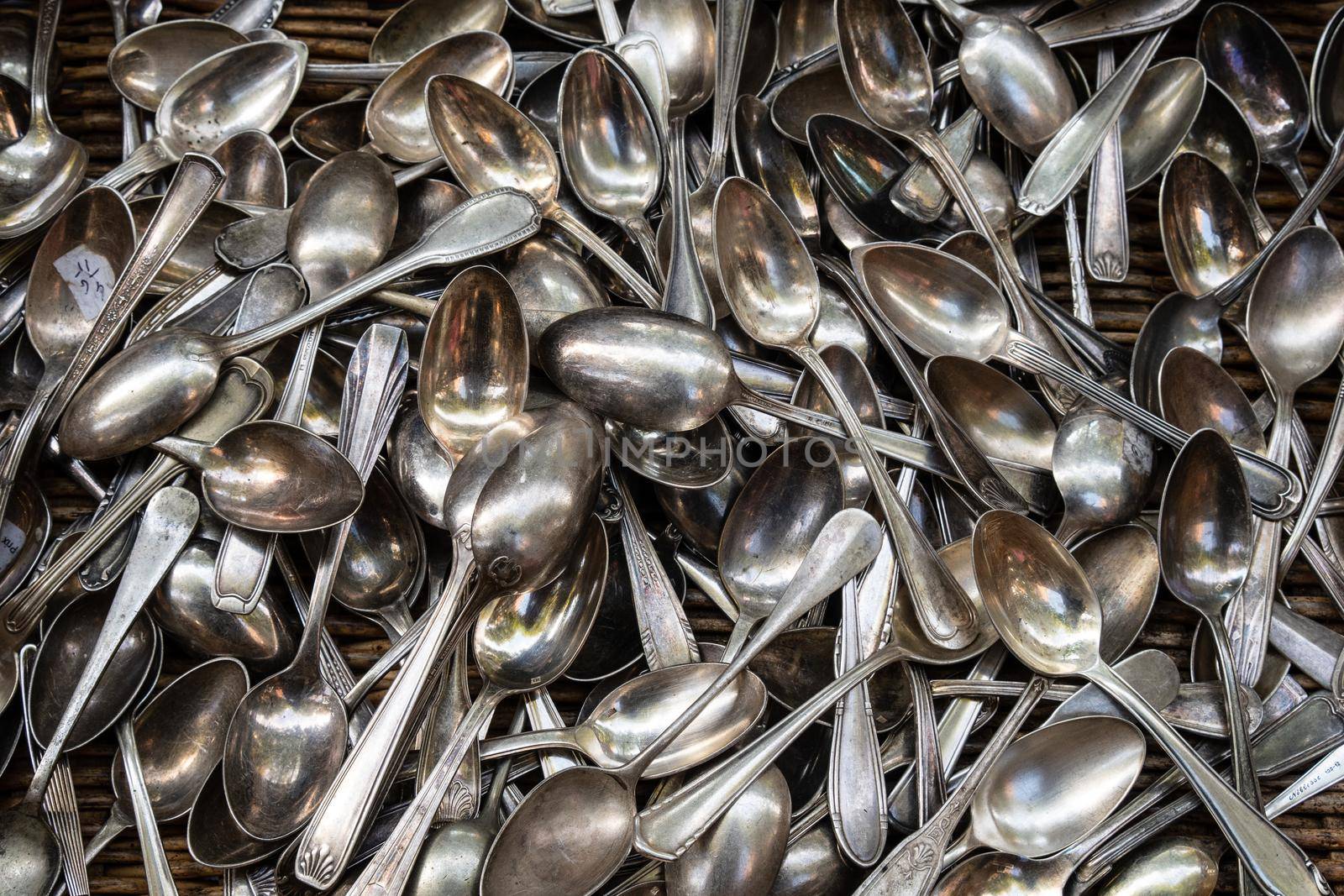 Heap of aged silver spoons by Tilo
