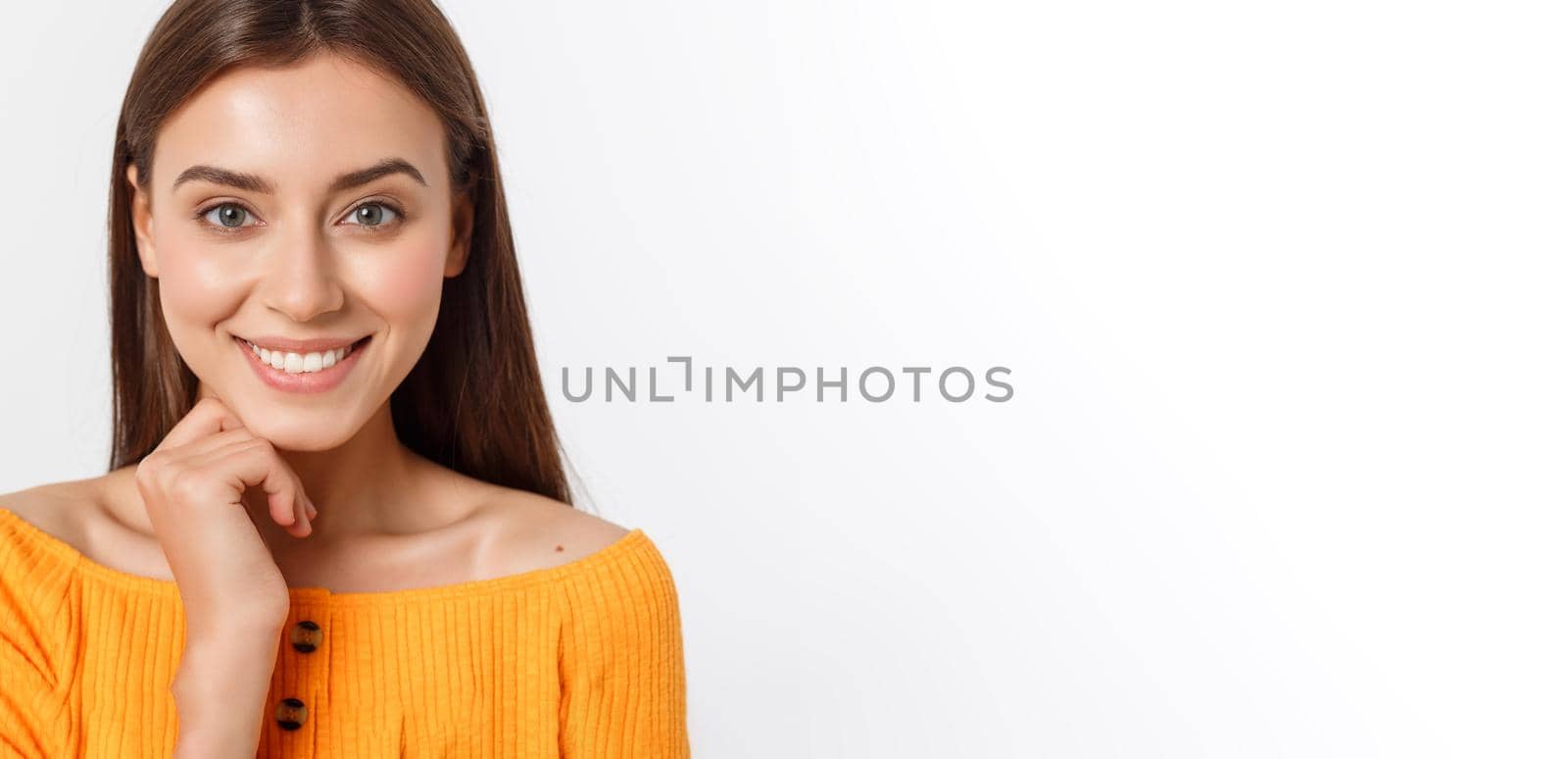 friendly smiling young woman with beatiful face portrait studio shot.