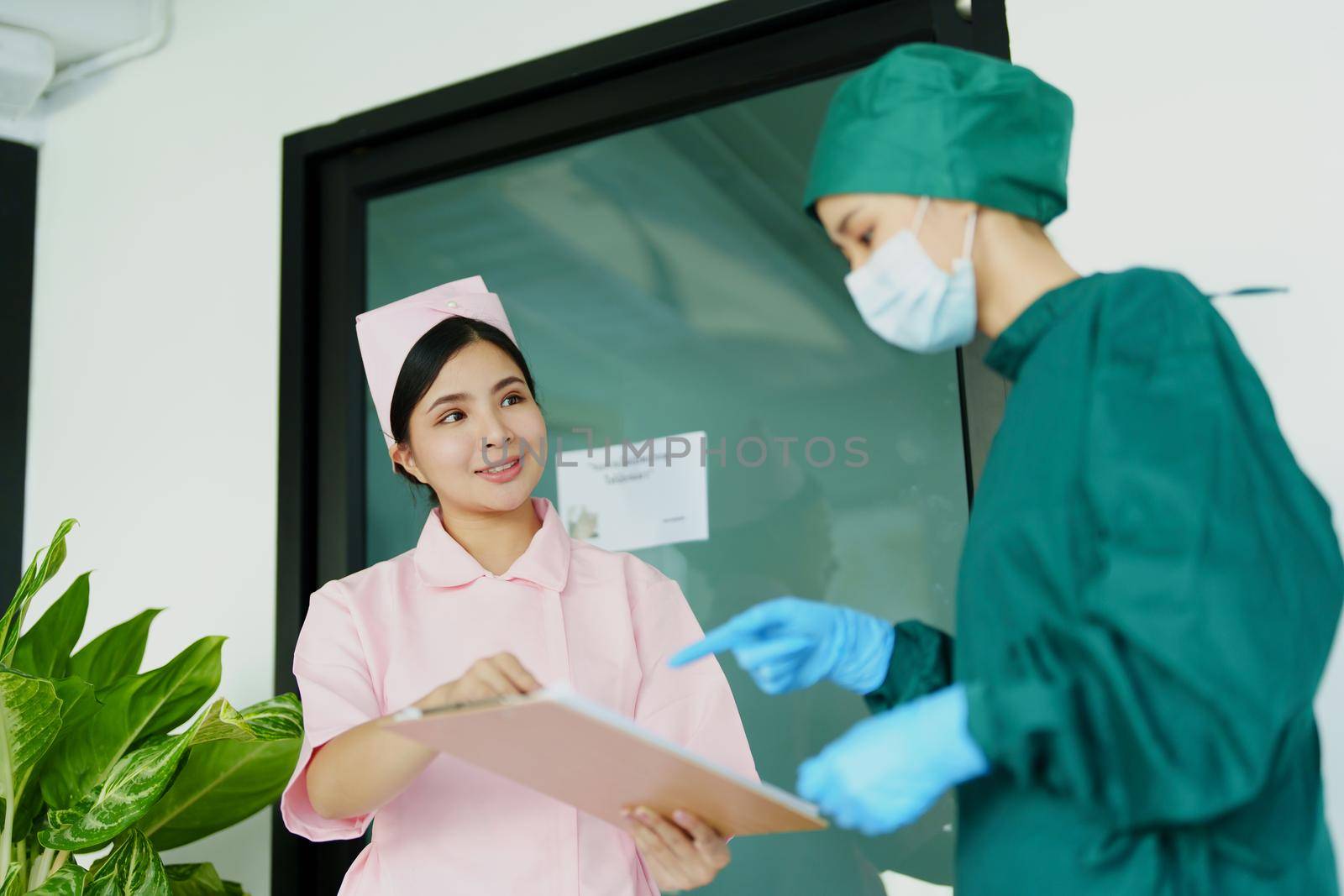 doctor and nurse talking before going into the operating room. by Manastrong