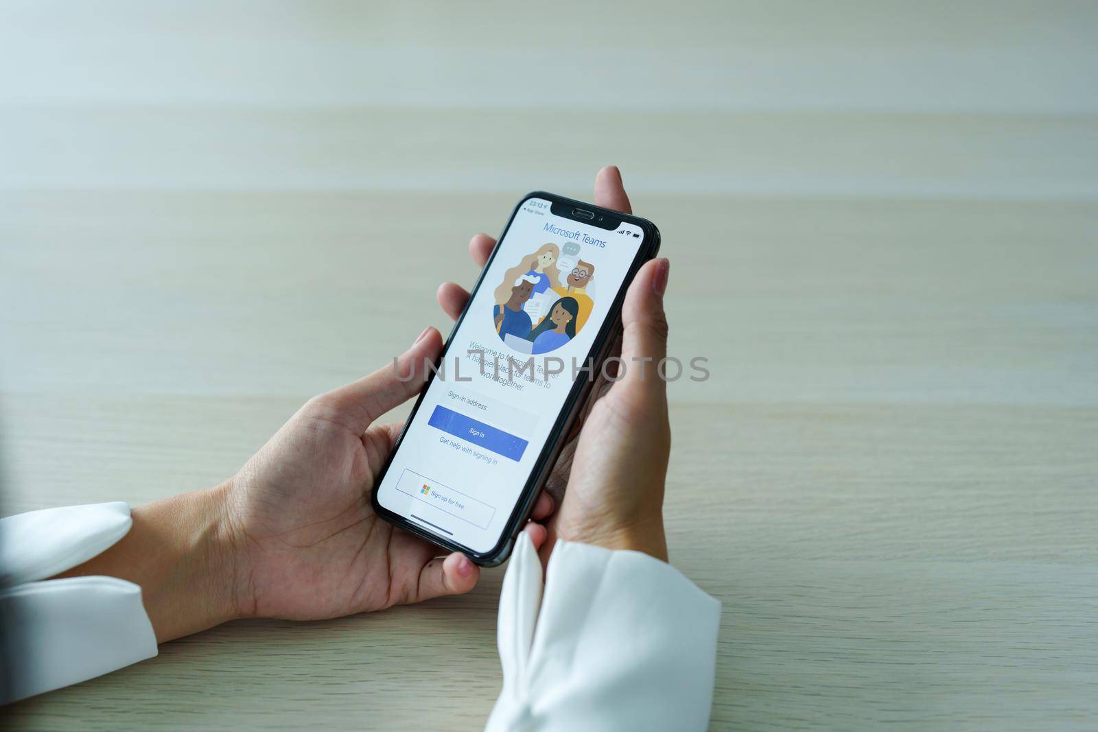 CHIANG MAI, THAILAND - Sep 08, 2022 : A working from home employee is downloading the Microsoft Teams social platform, ready for remote working in isolation from home