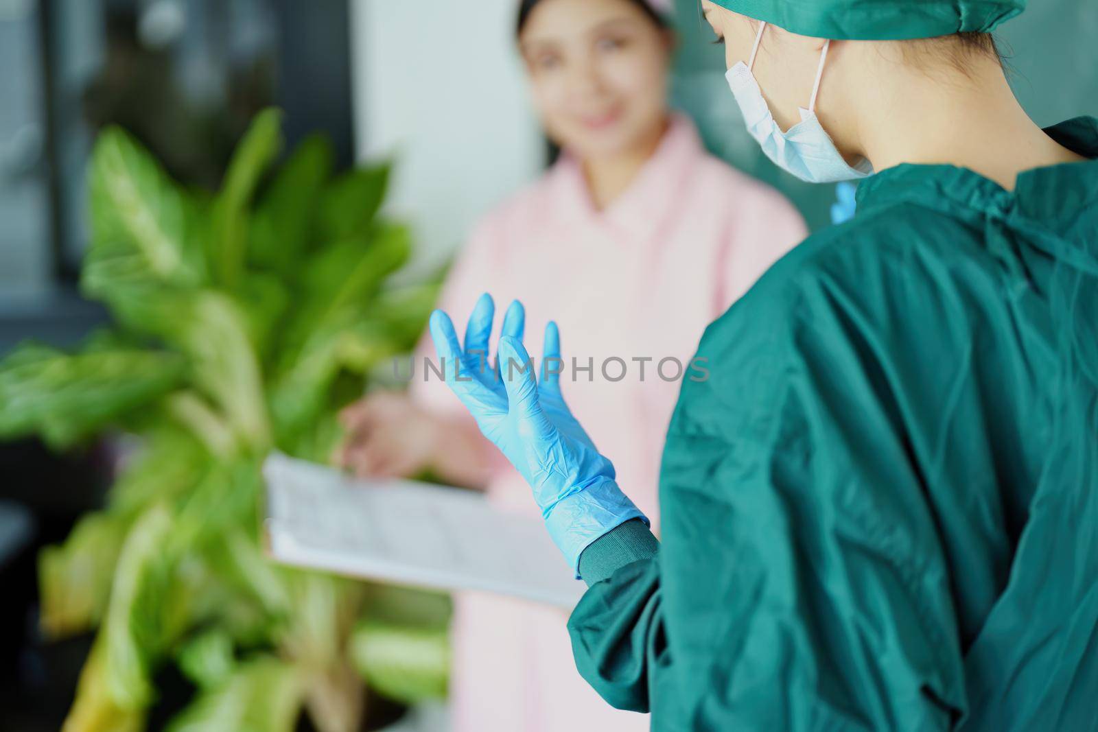 doctor and nurse talking before going into the operating room. by Manastrong