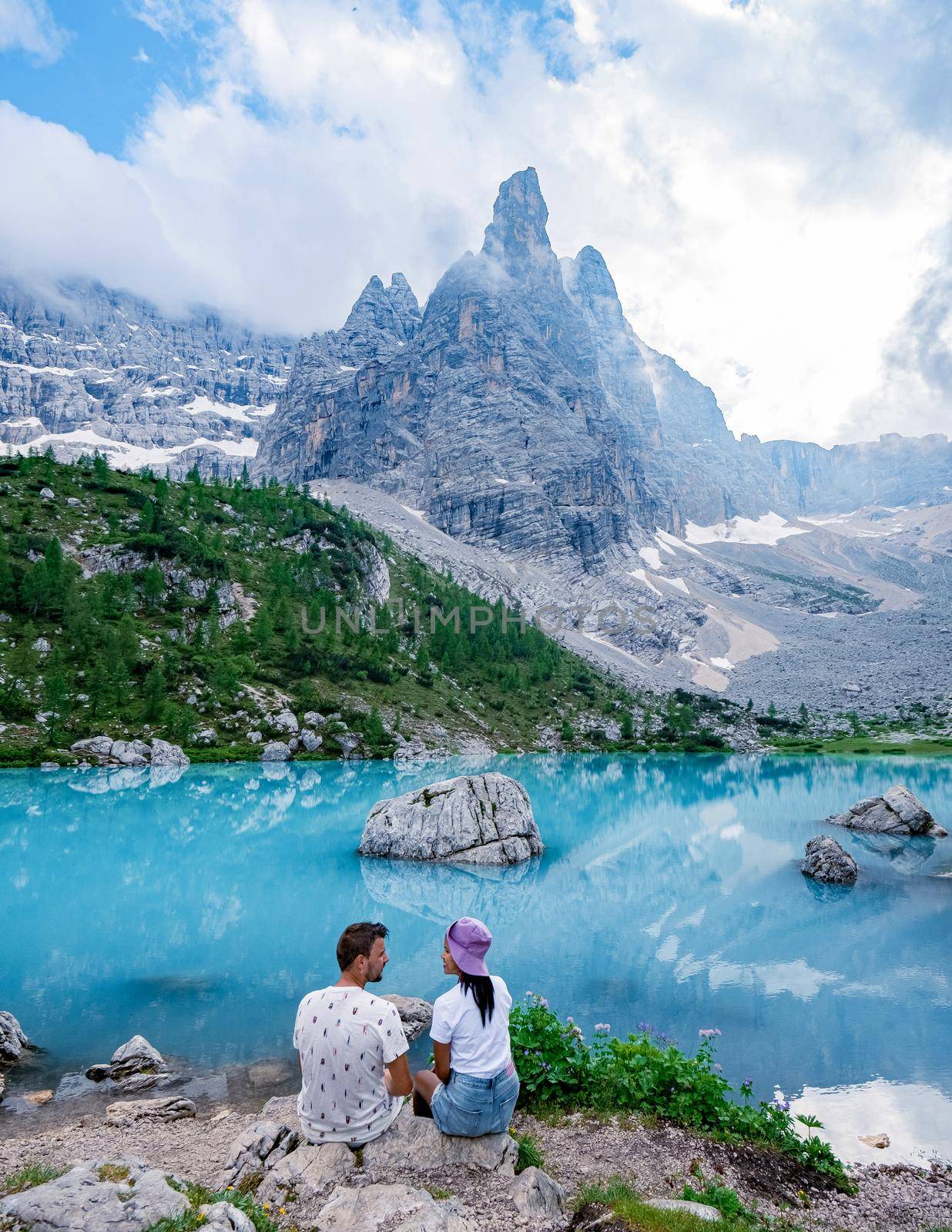 Lake Sorapis Lago di Sorapis in the Dolomites is a popular travel destination in Italy. Europe, the Couple visited the blue-green lake in the Italian Dolomites, Beautiful Lake Sorapis
