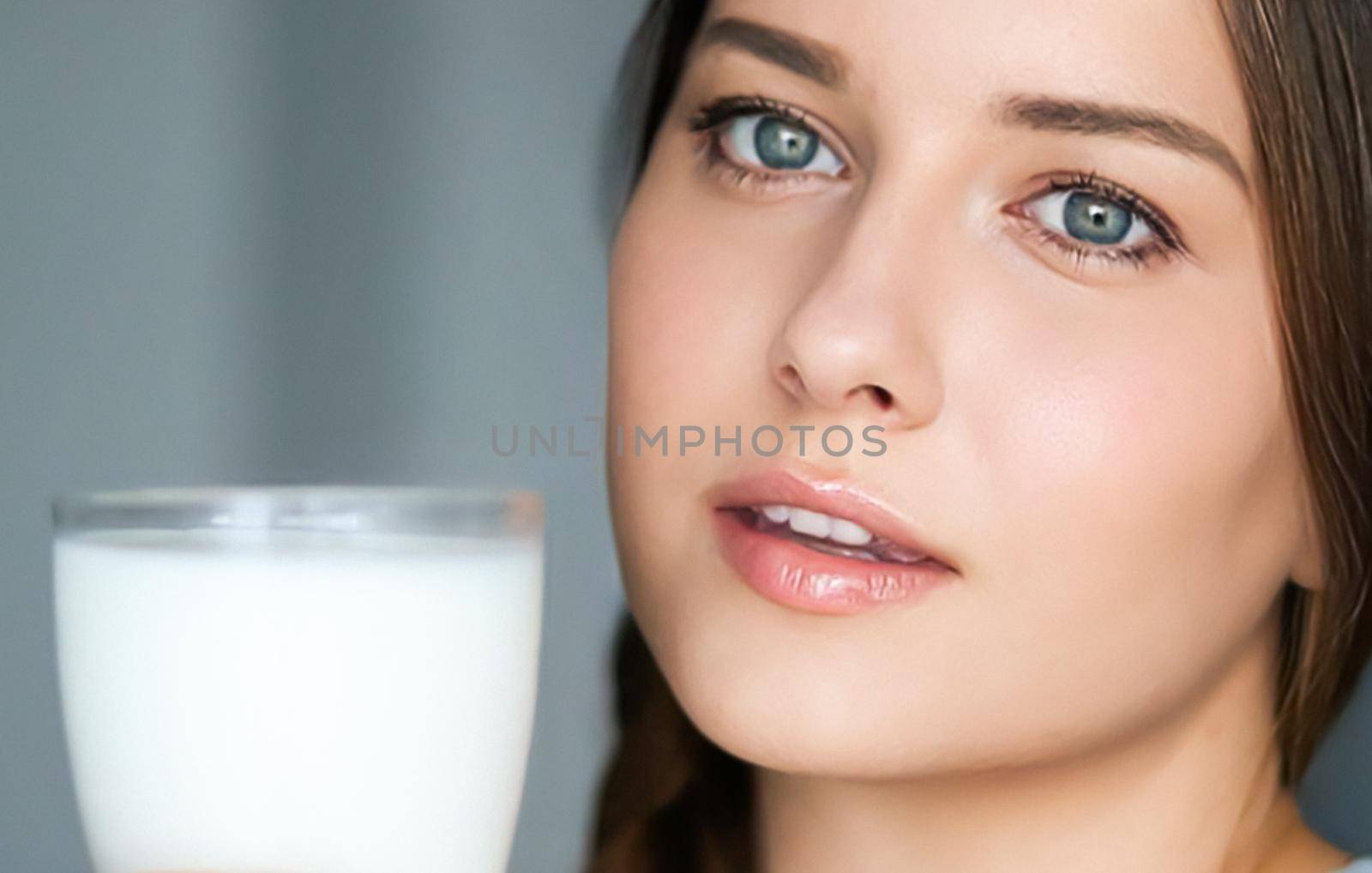 Diet and wellness, young woman with glass of milk or protein shake cocktail, portrait