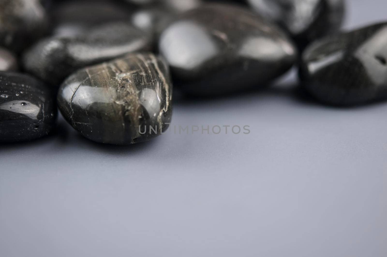row zen stones on gray paper background by inxti