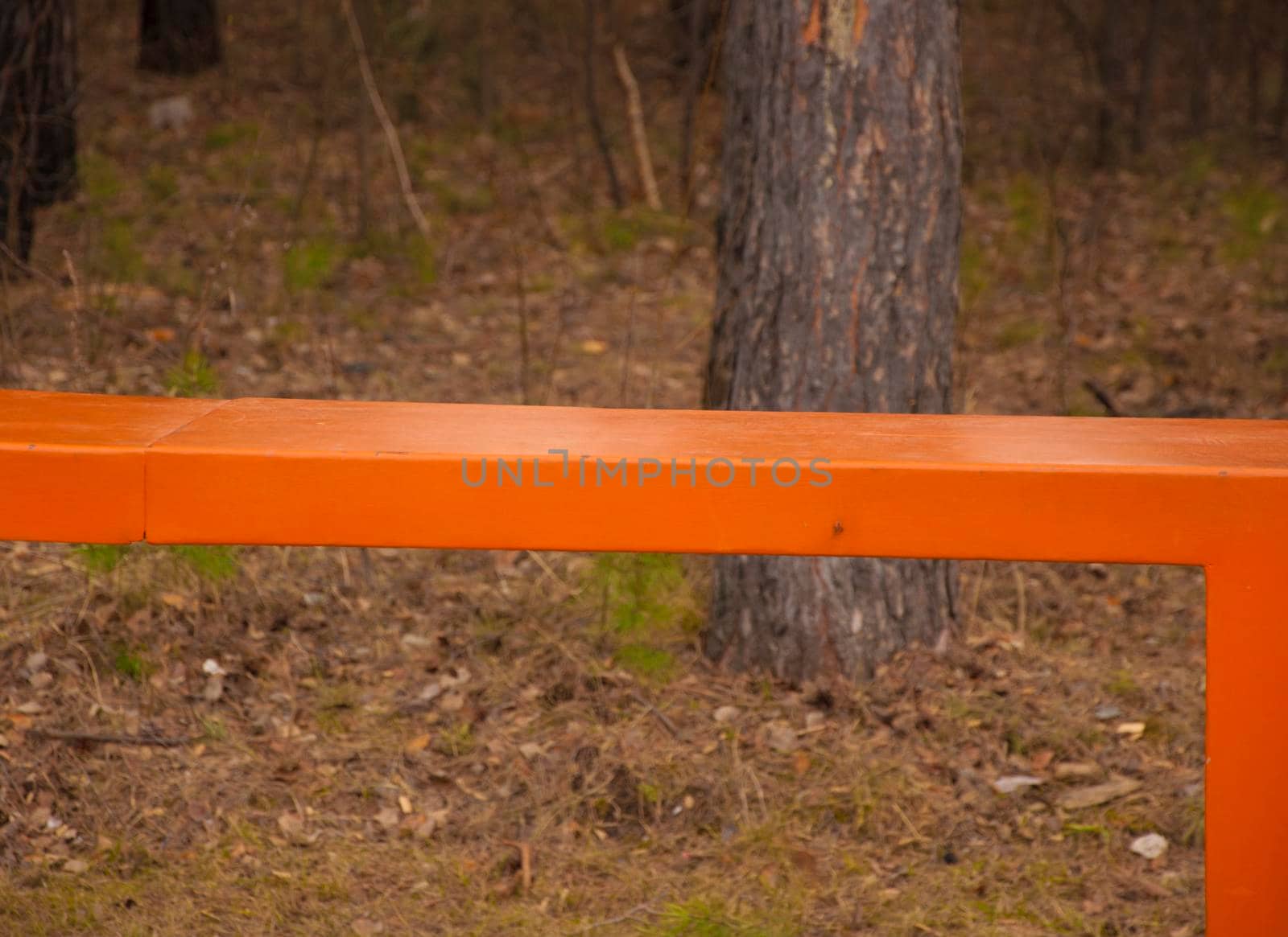 orange metal bench in the park