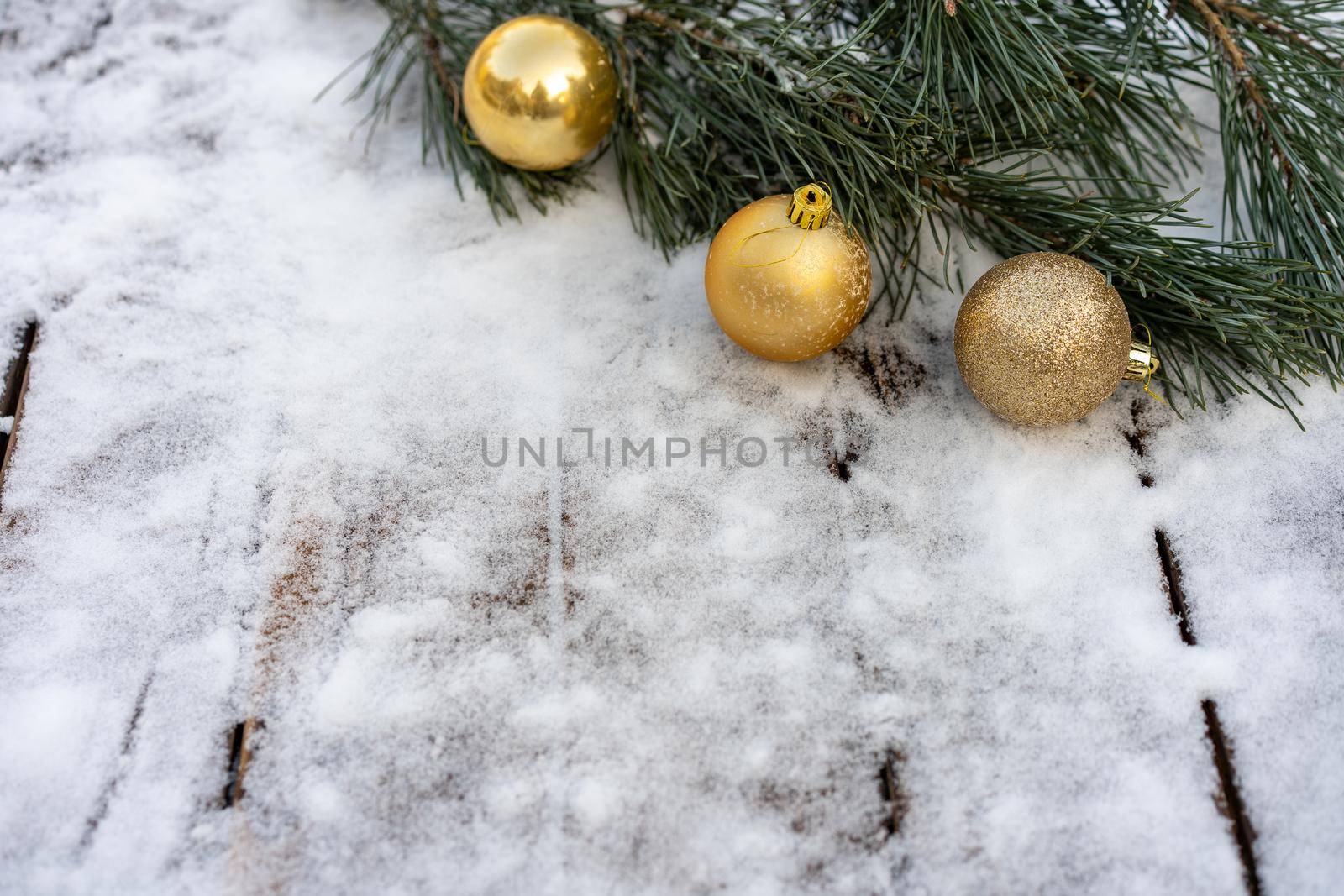 Winter background. Empty wooden plank with snowy border with pine branch and christmas ball decoration, copy space for text Wood table to. For product display Christmas time mock up