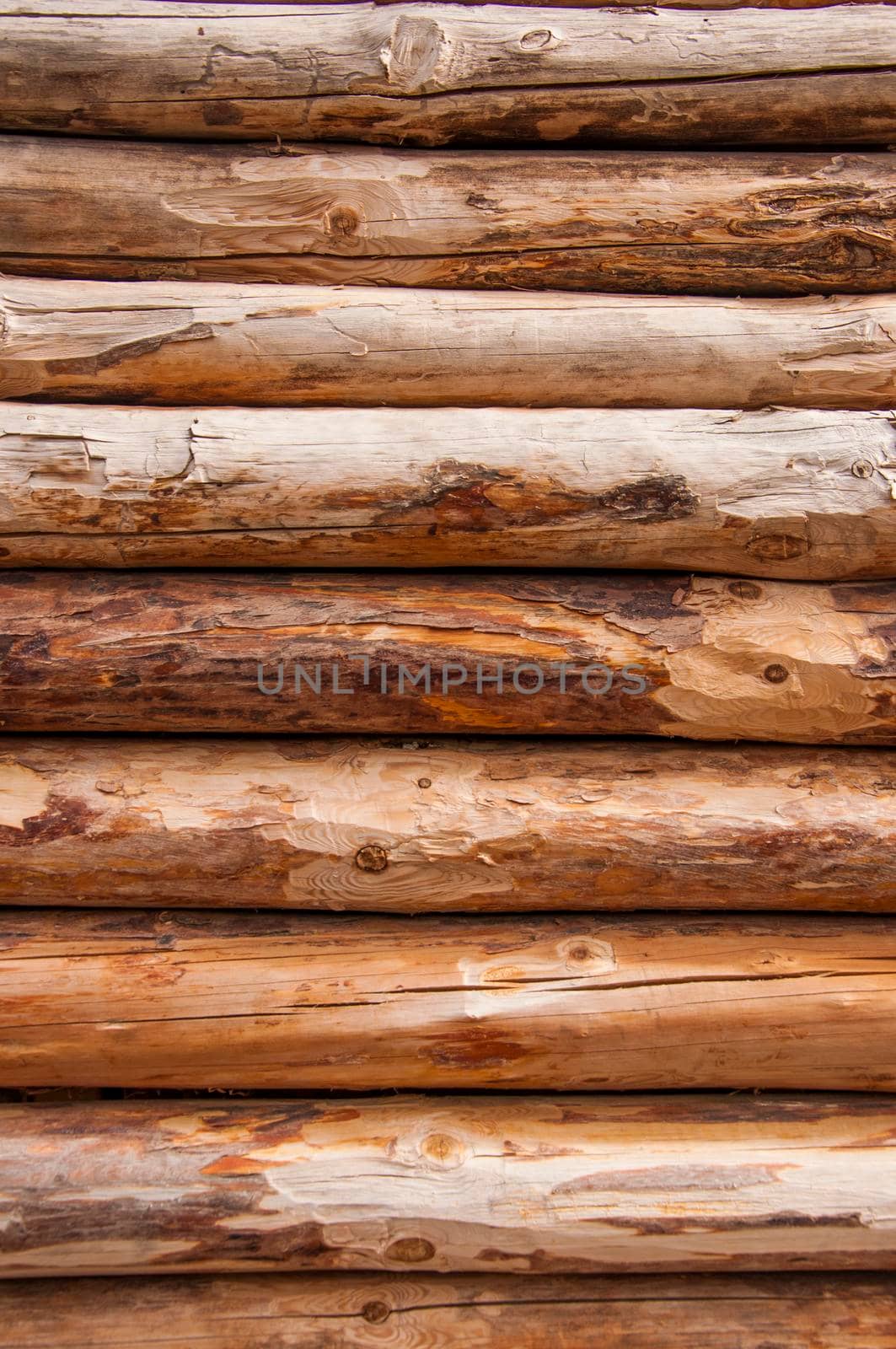 Natural wooden background - closeup of chopped firewood. Firewood stacked and prepared for winter Pile of wood logs