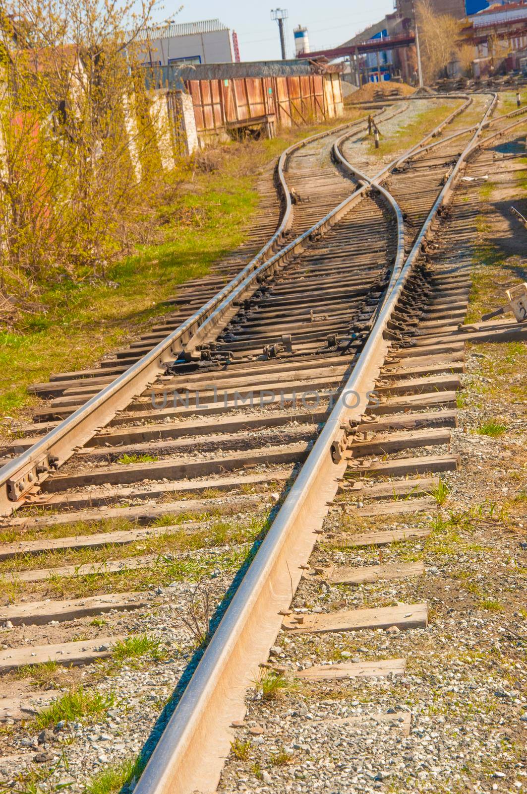 Fragment of a railway track with rails and sleepers in the countryside