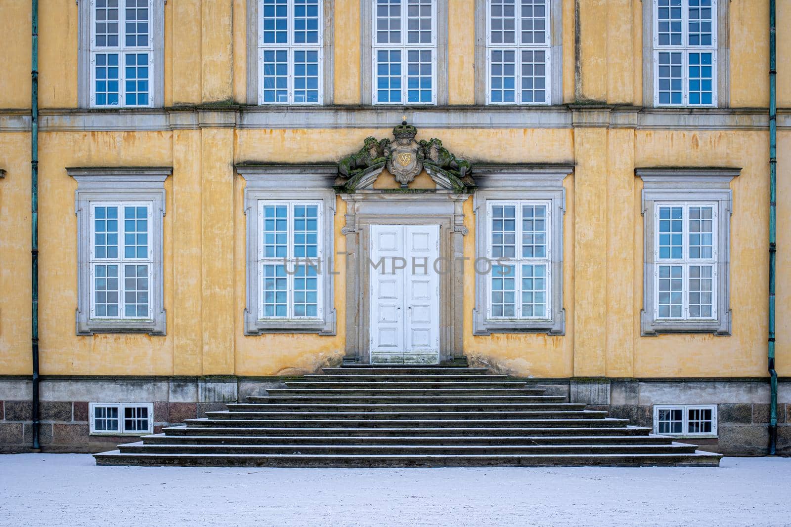 Copenhagen, Denmark - January 31, 2022: A white wooden entrance door to Frederiksberg Castle.