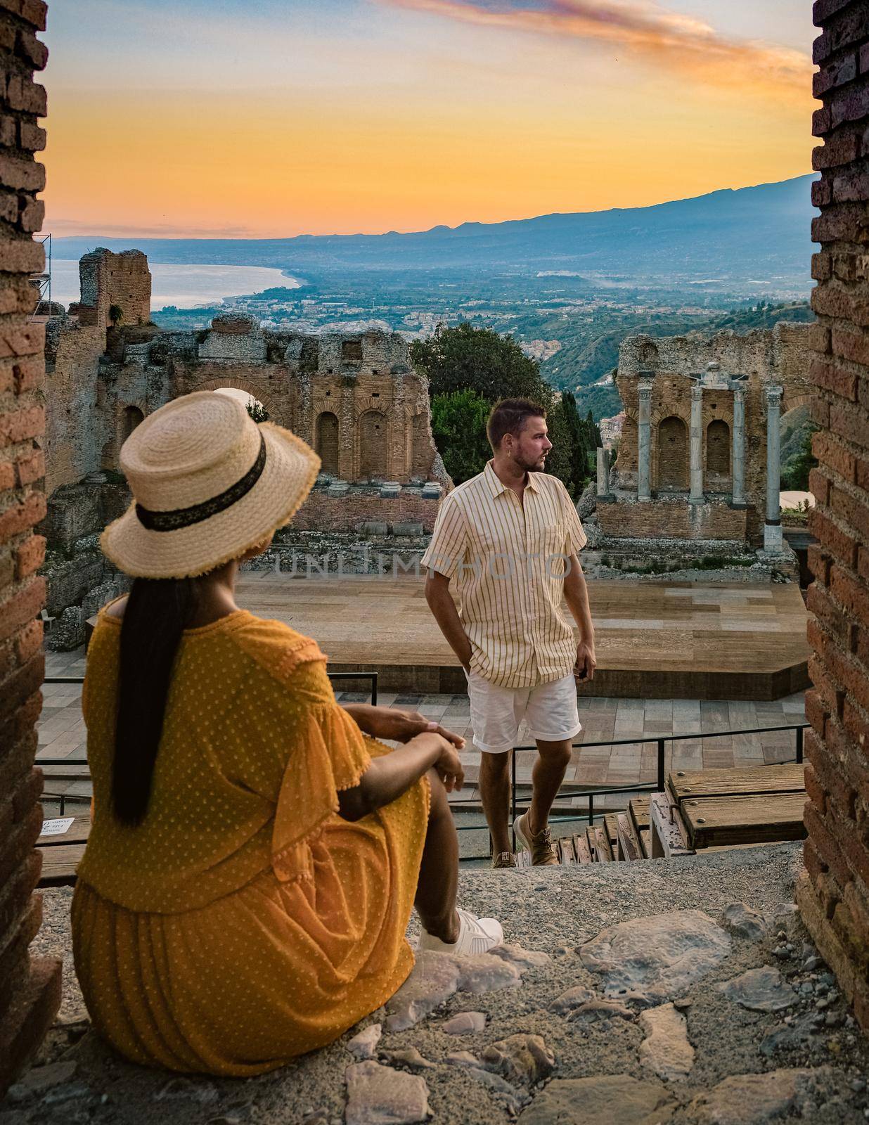 couple men and woman visit Ruins of Ancient Greek theatre in Taormina Sicily. by fokkebok