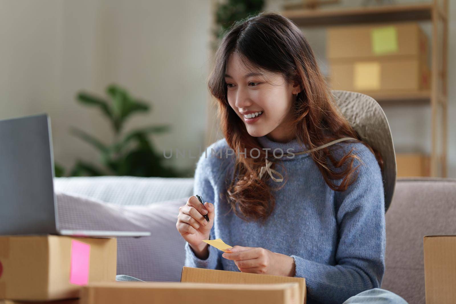 Asian SME business woman working at home office. online shopping concept.