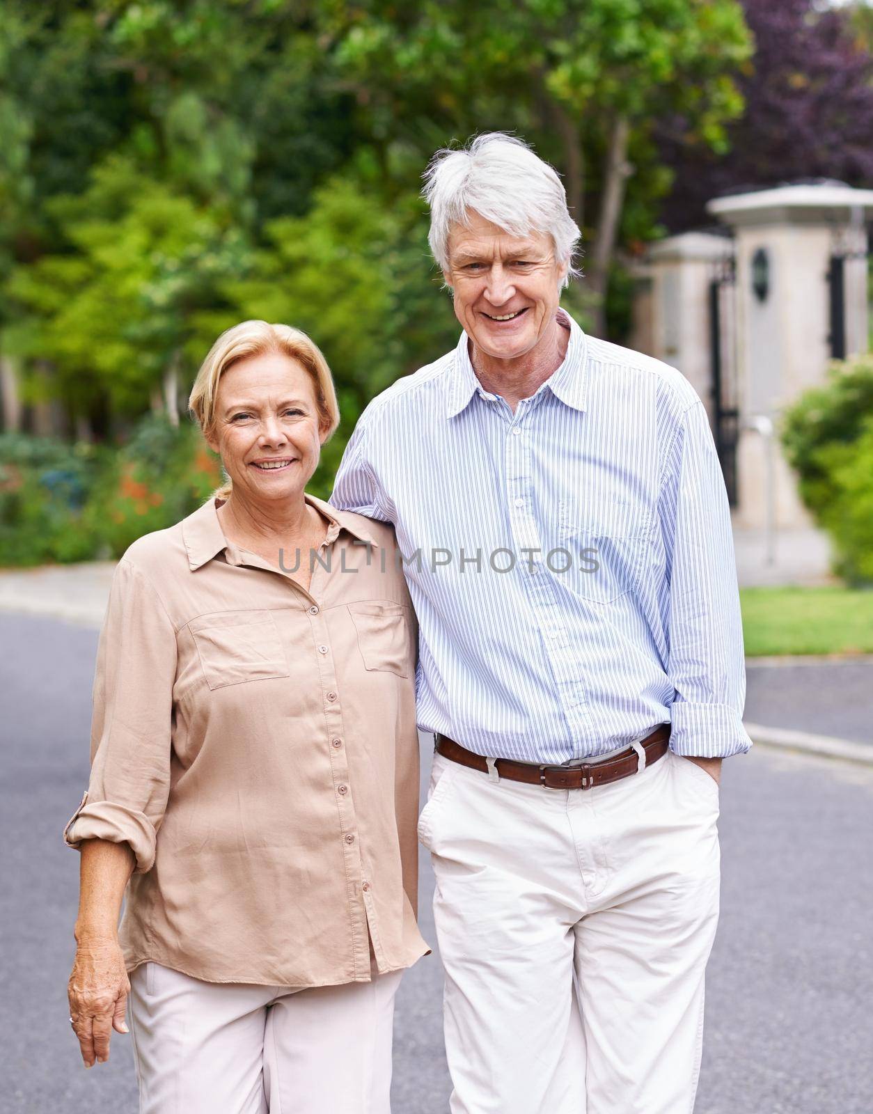 Live everyday like its your last. Portrait of an old married couple outdoors. by YuriArcurs