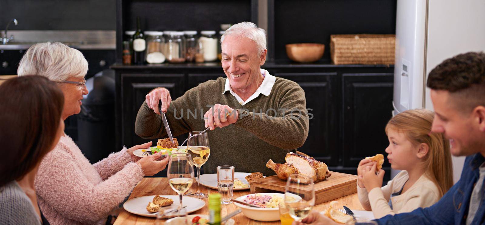 Get some salad. a family sharing a meal around the dinner table