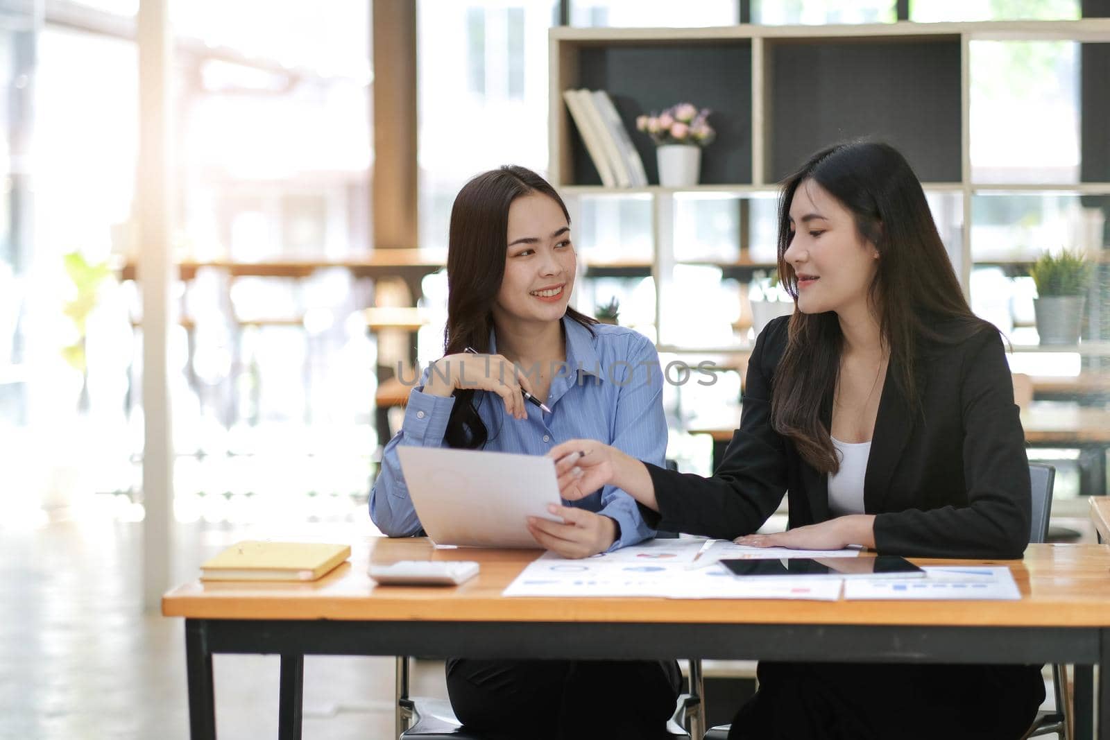 Asian business adviser meeting to analyze and discuss the situation on the financial report in the meeting room.Investment Consultant,Financial Consultant,Financial advisor and accounting concept.