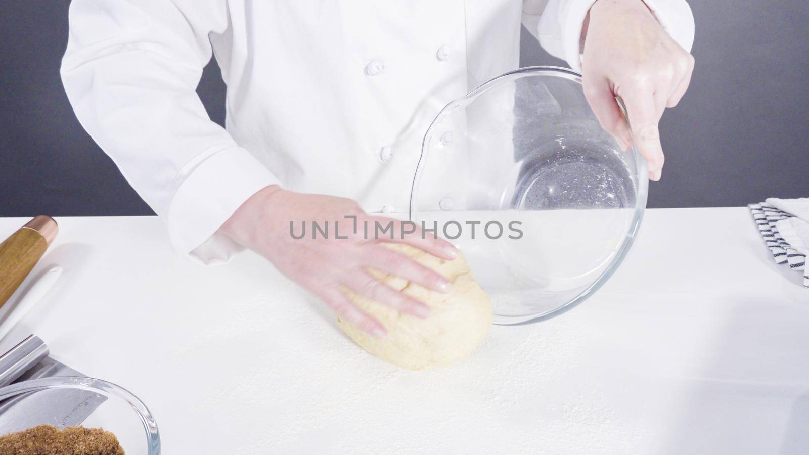 Knitting dough by hand to bake cinnamon rolls.