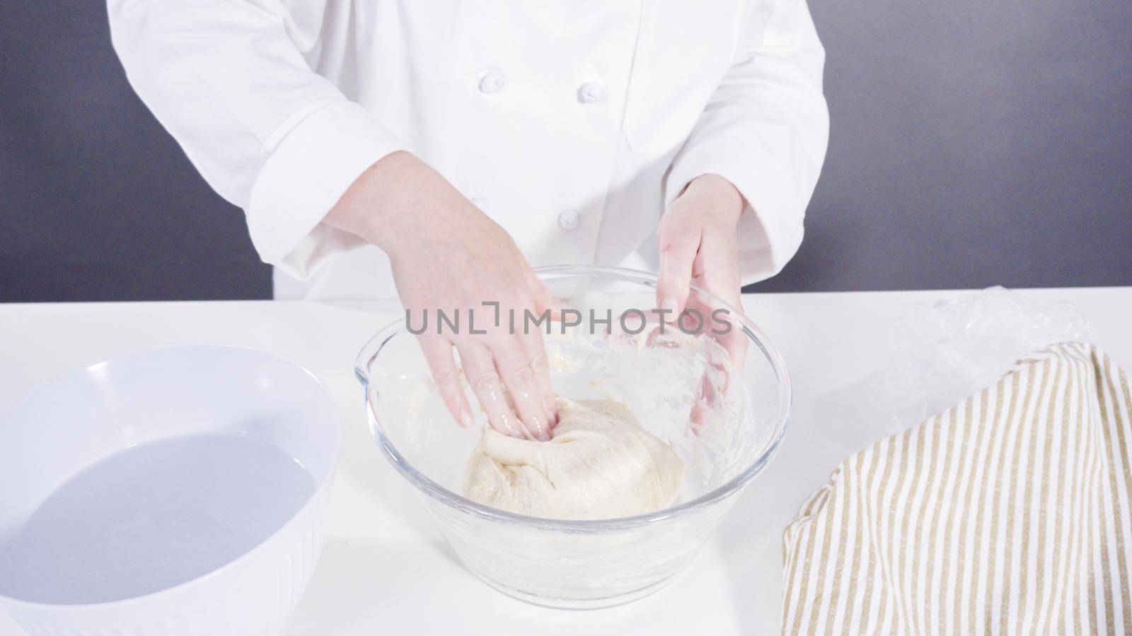 Knitting dough by hand to bake cinnamon rolls.