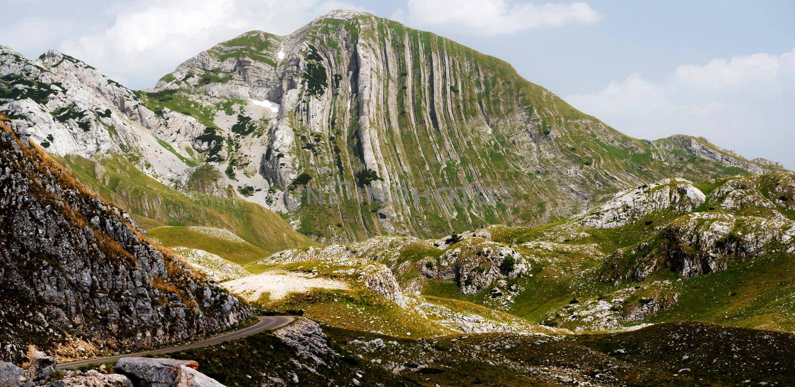 Scenic mountains view with serpentine road in National park Durmitor, Montenegro. Amazing balkan nature panorama