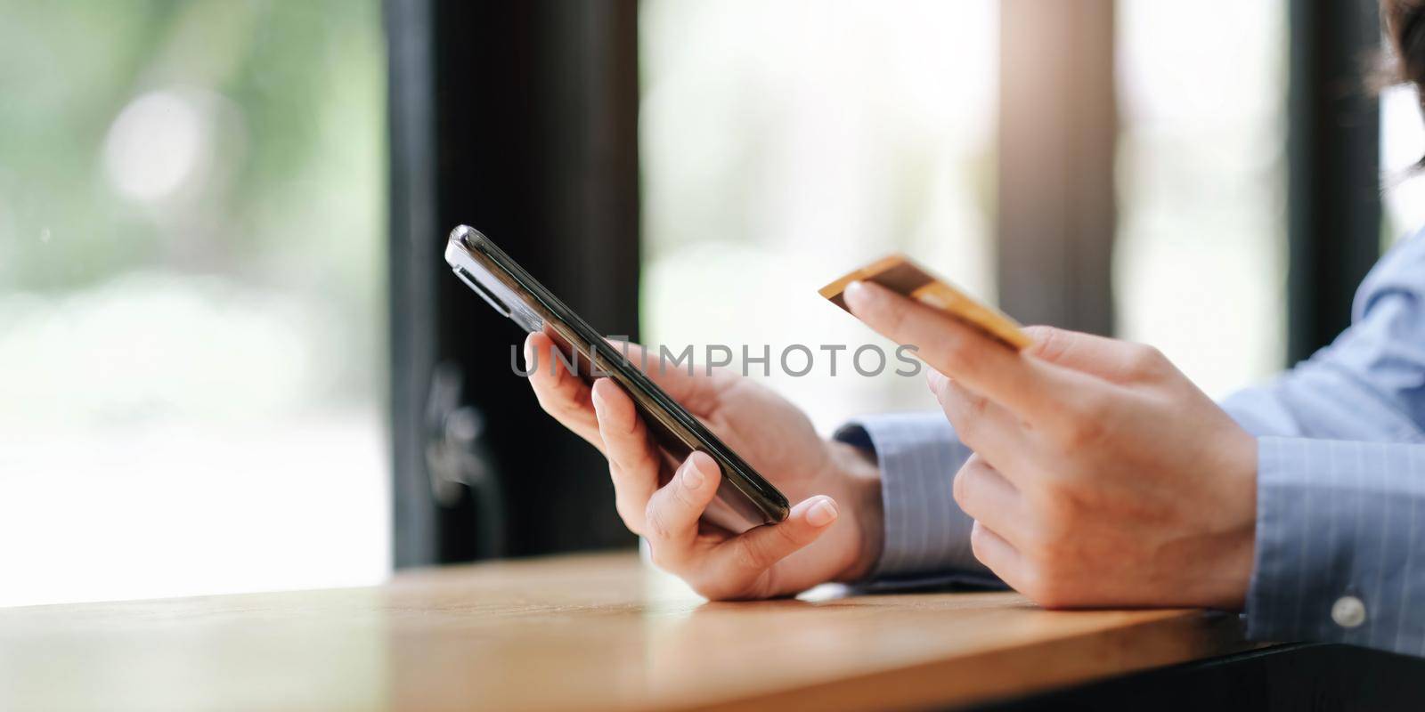 Woman hands holding smartphone shopping online with credit card. Online Payment. Online shopping concept..