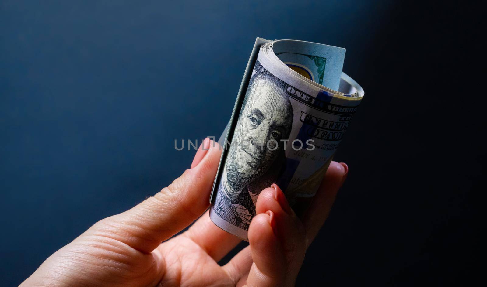 Hand holding dollar USA banknotes. with portrait of president. American currency in cash