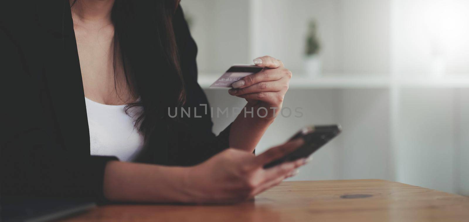 Woman hands holding smartphone shopping online with credit card. Online Payment. Online shopping concept..