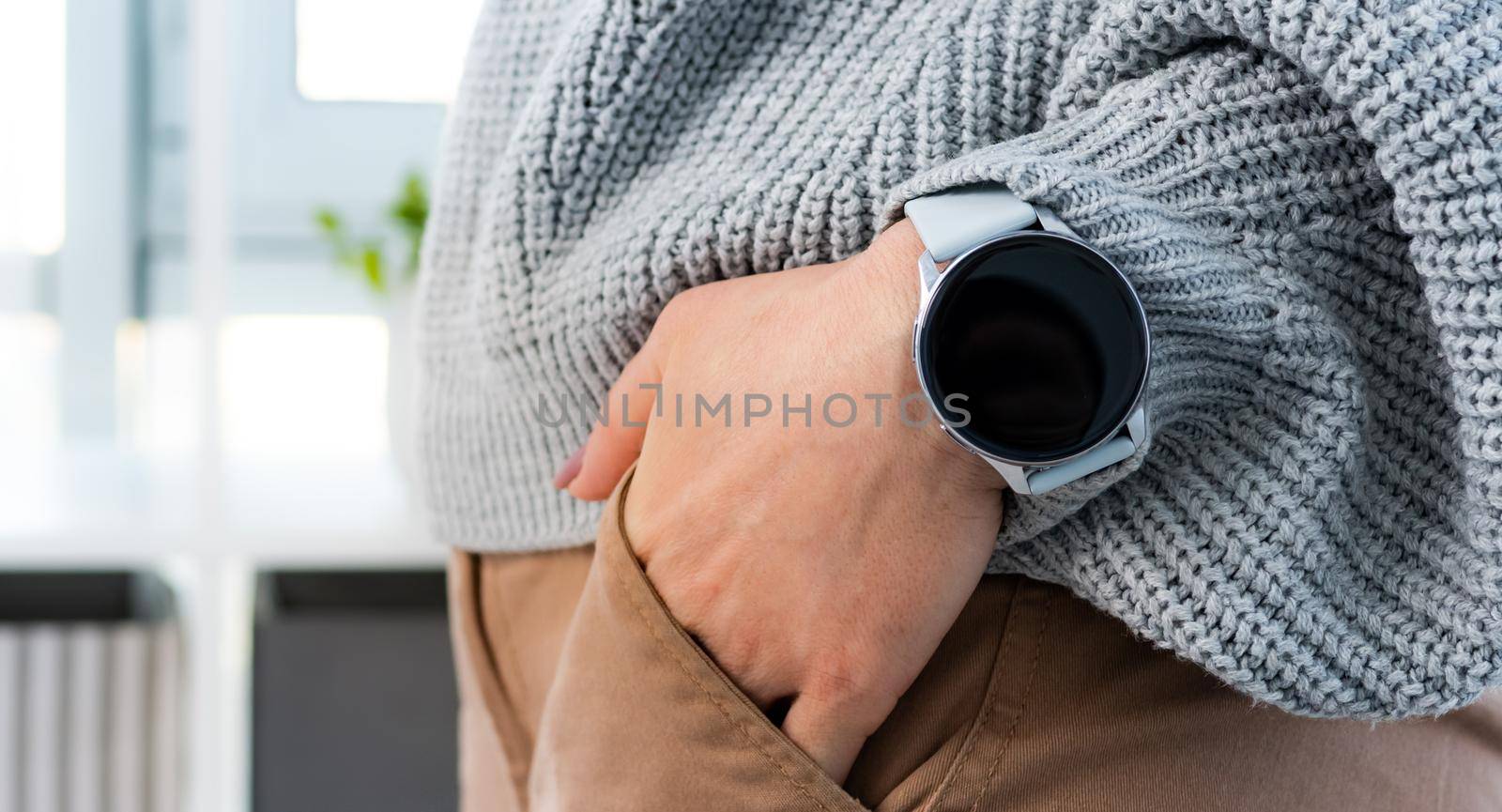 Person with smart watch with digital screen with copy space on his wrist hand. Girl with innovative electronic clock gadget
