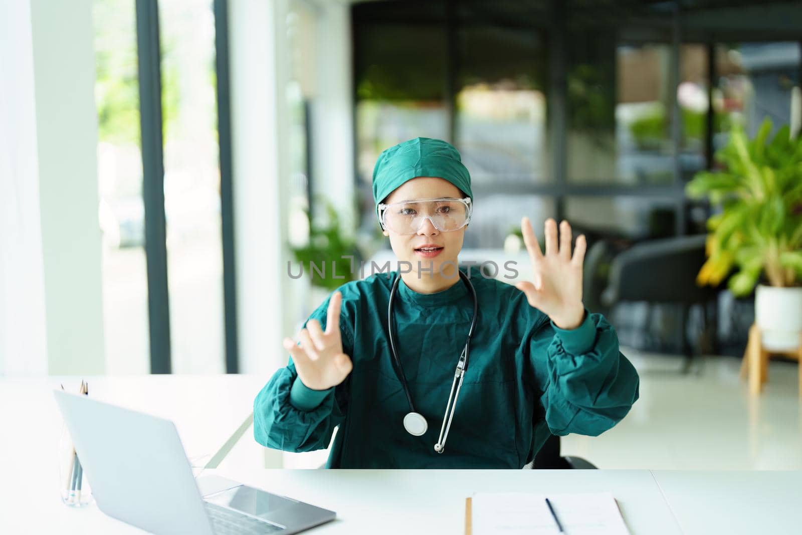 Asian healer showing gestures, describing body structure patterns.