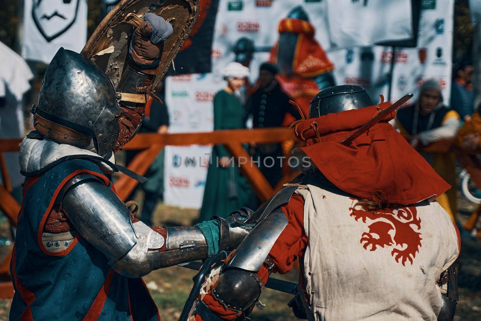 Reconstruction of medieval jousting matches. Battle of two knights from different historical clubs in the arena. Sword fighting. Bishkek, Kyrgyzstan - October 13, 2019