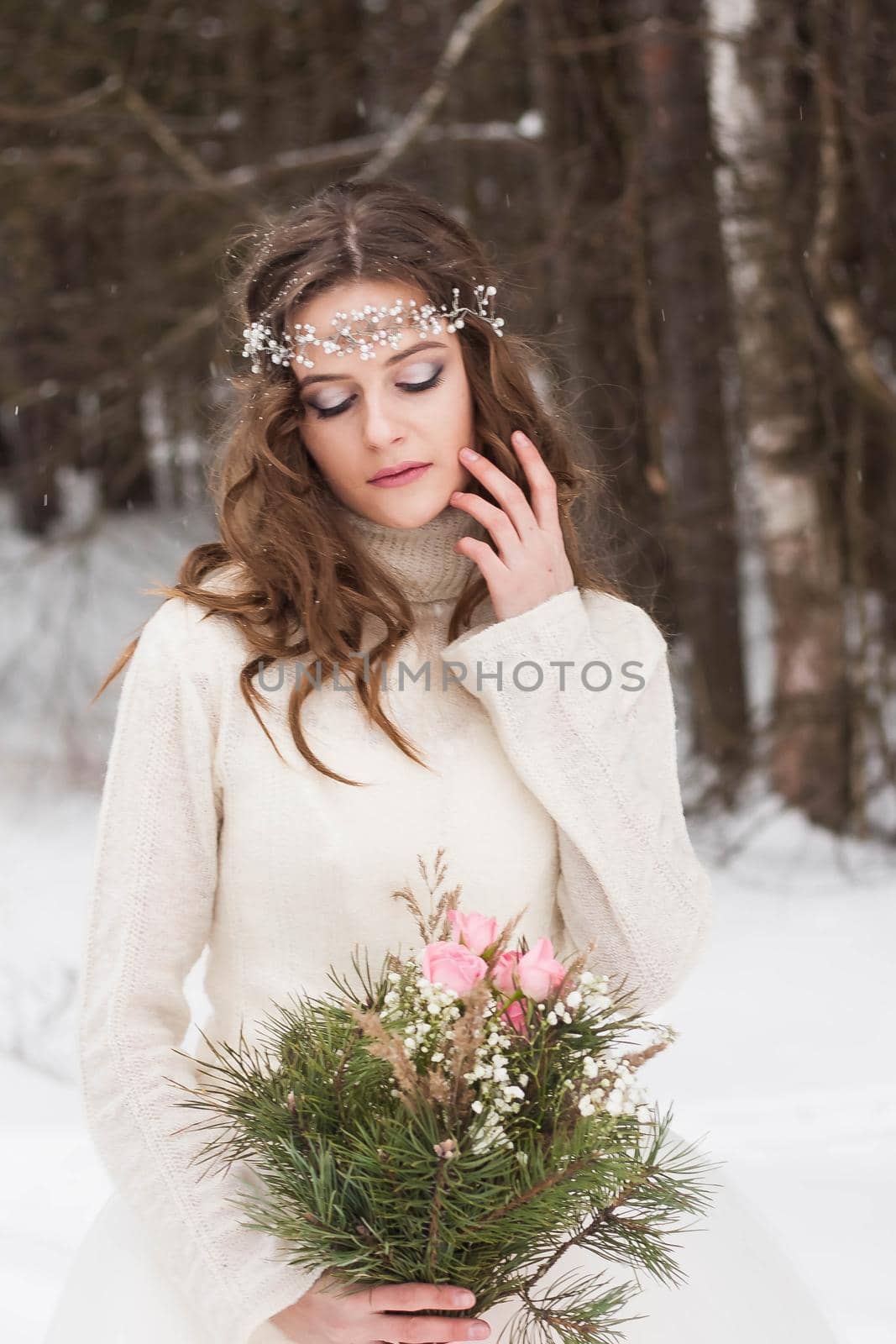 Beautiful bride in a white dress with a bouquet in a snow-covered winter forest. Portrait of the bride in nature by Annu1tochka