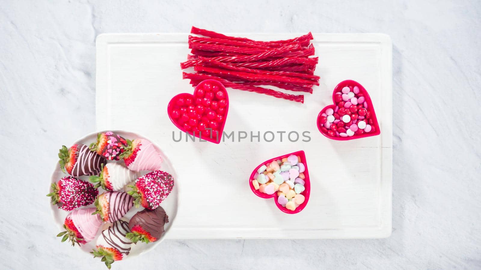 Flat lay. Step by step. Cheese board with candies and cookies for Valentines Day.