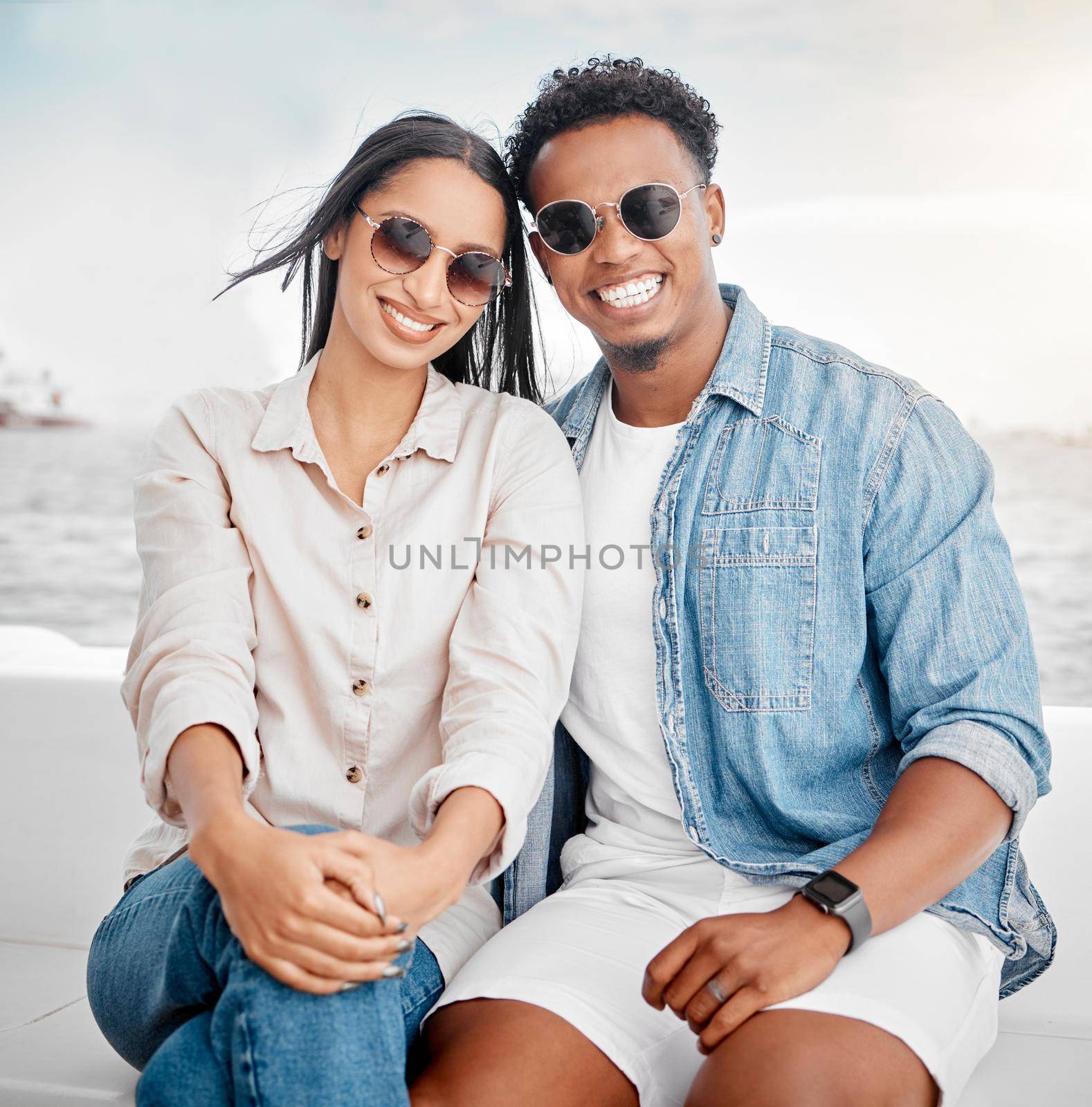 Sunglasses, summer and couple portrait at the beach for holiday, vacation with casual fashion style. Gen z or millennial woman, man or people smile together with ocean, sea and clear sky mock up by YuriArcurs