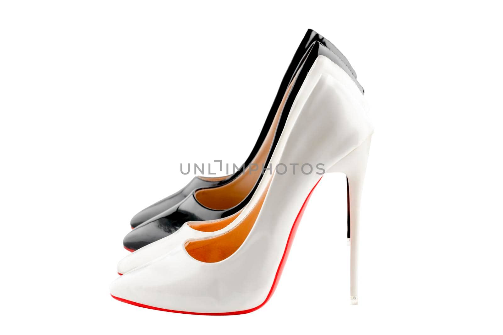 two pairs of black and white women's high-heeled shoes on white background