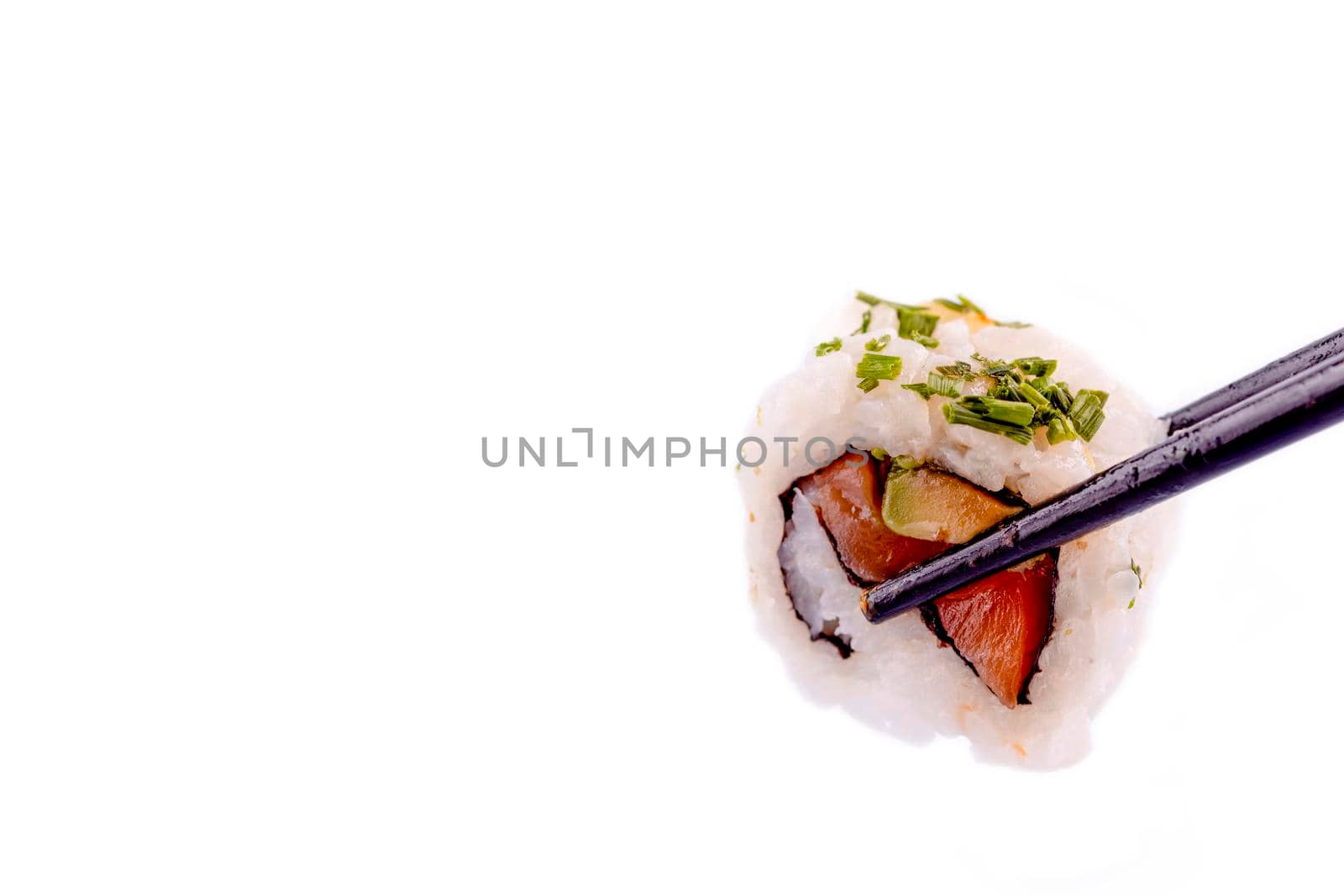 Close up of delicious japanese food with sushi roll with salmon, tuna, shrimp with wooden chopsticks on white background Space for text by Iryna_Melnyk