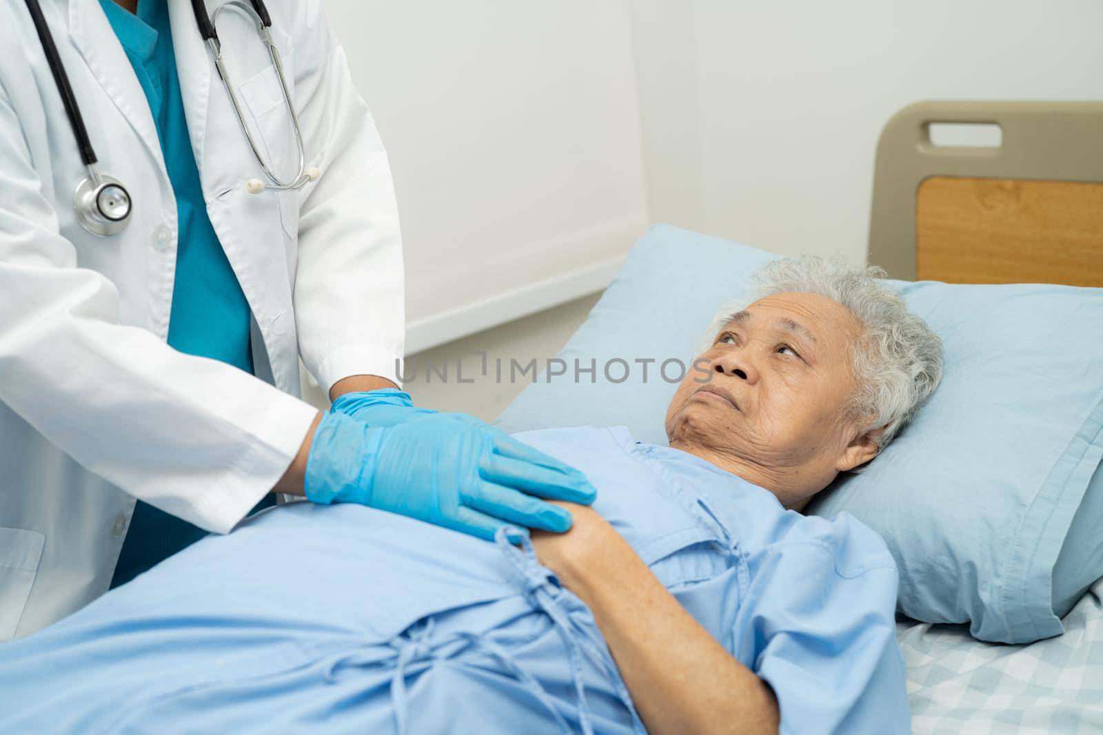 Holding hands Asian senior or elderly old lady woman patient with love, care, encourage and empathy at nursing hospital ward, healthy strong medical concept by pamai