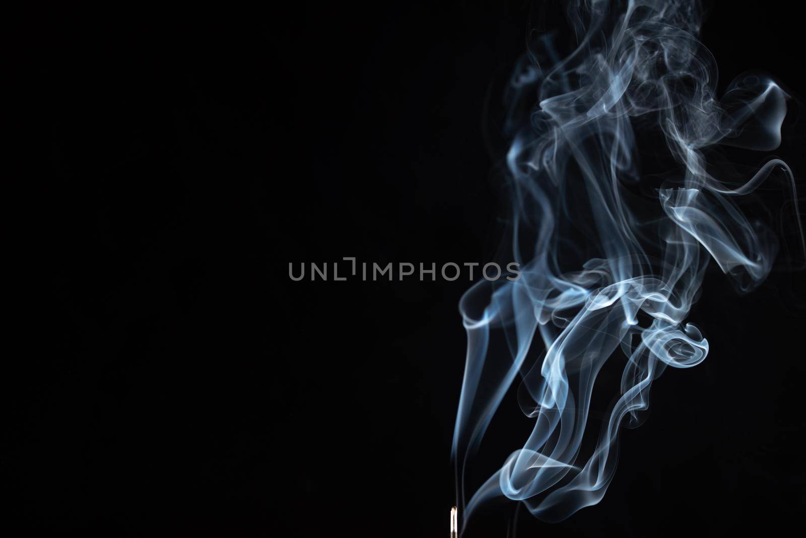 incense stick with smoke against black background by Iryna_Melnyk
