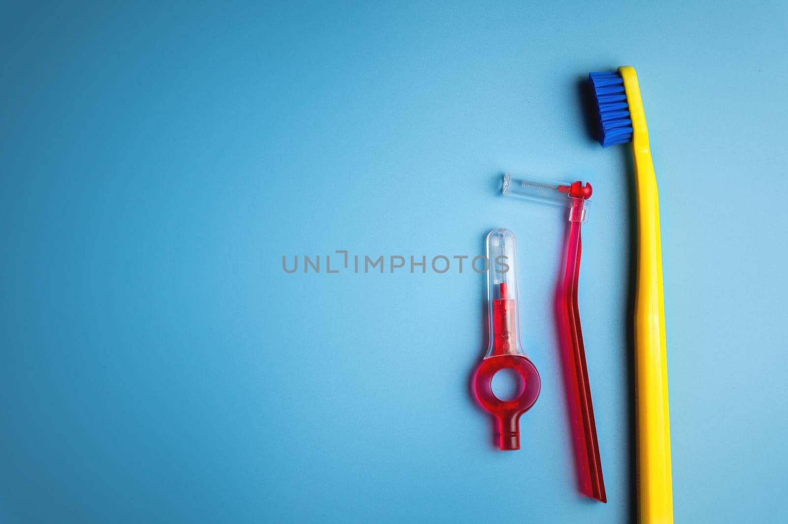 Dental hygiene. Toothbrush, hygienic brushes on a blue background. flat top view.