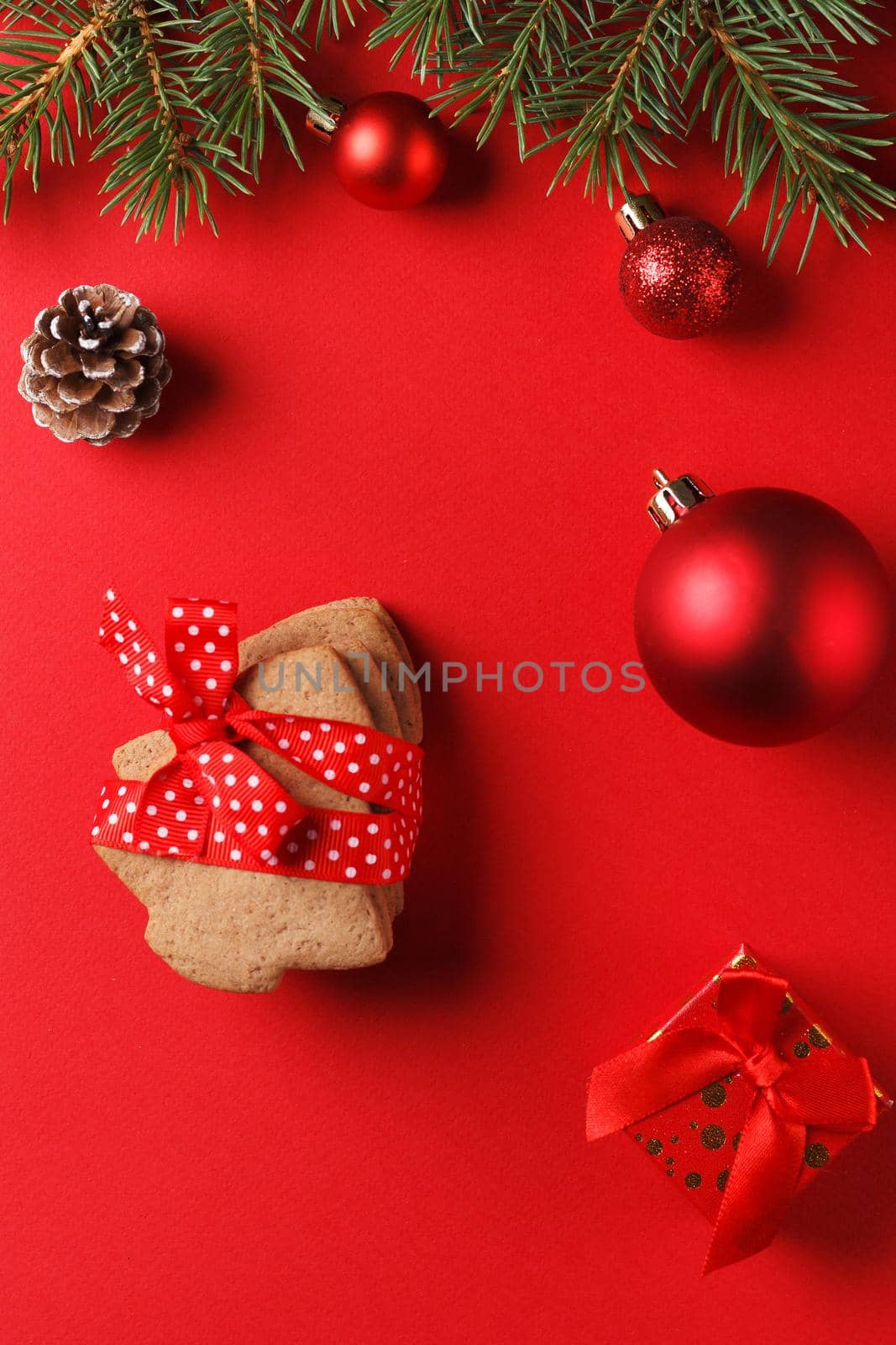 Delicious gingerbread and Christmas decor on a red background.