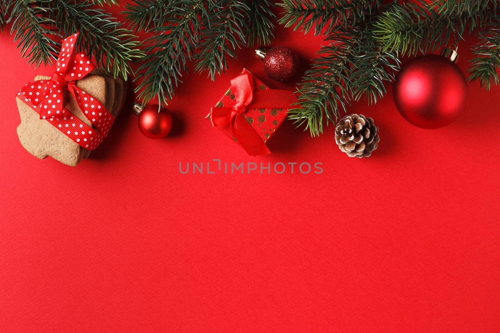 Delicious gingerbread and Christmas decor on a red background. copy space.