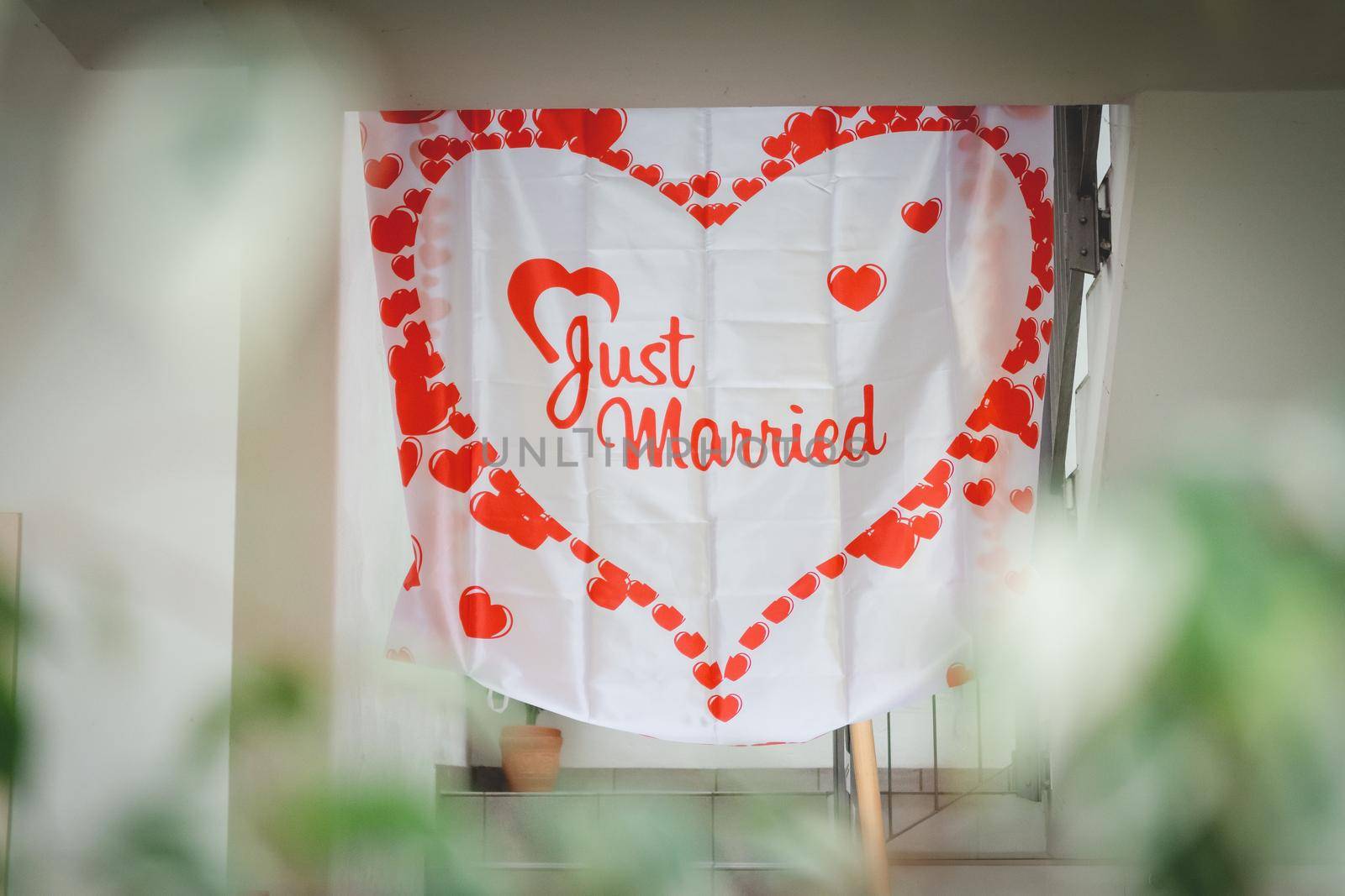 Heart-shaped papers with Just Married text in the middle by bildgigant