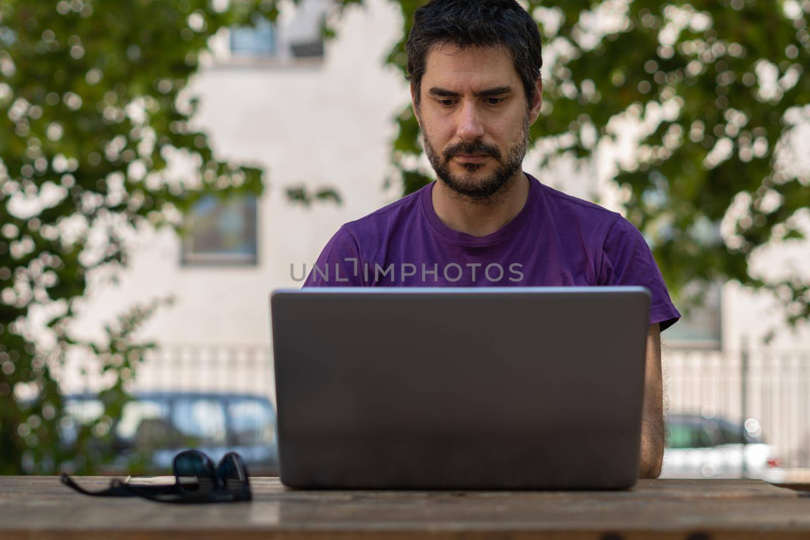 man with pc in the park by joseantona